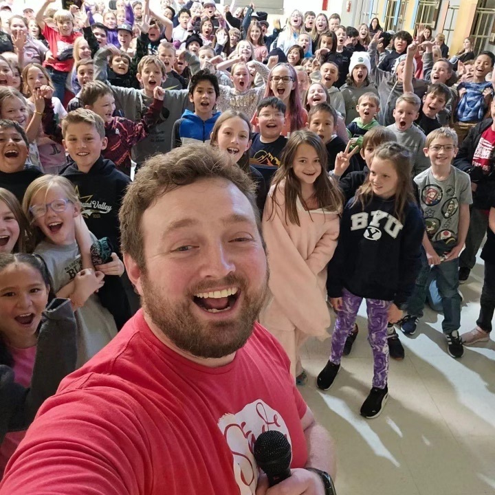Nate Webb takes a picture with the elementary students